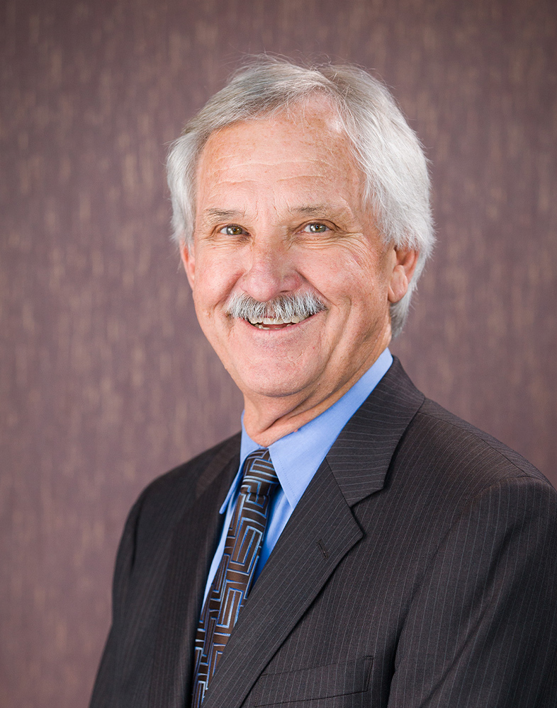 Smiling older man in business suit portrait.