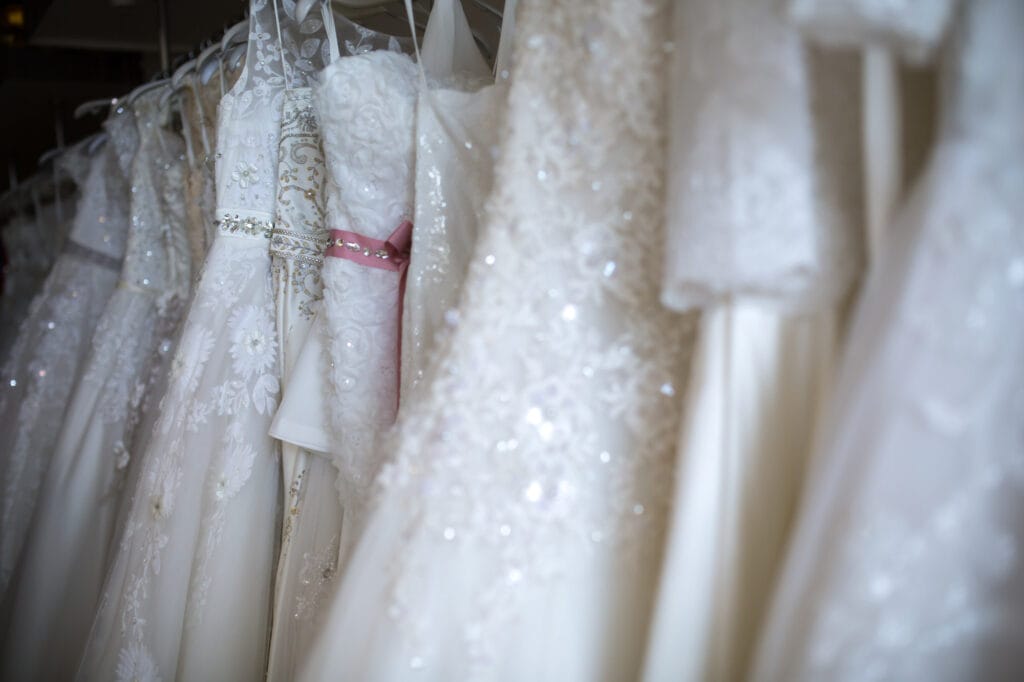 Assorted white wedding dresses on hangers